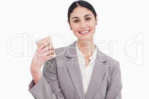 Smiling businesswoman with paper cup