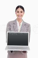 Smiling businesswoman showing screen of her laptop