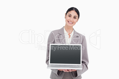 Smiling businesswoman showing screen of her notebook