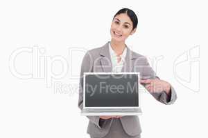 Businesswoman pointing at screen of her laptop