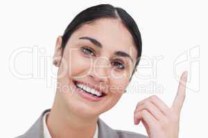 Close up of smiling businesswoman pointing up