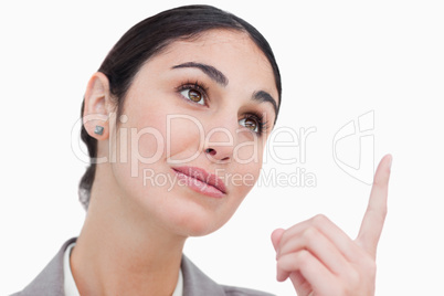 Close up of businesswoman looking and pointing up