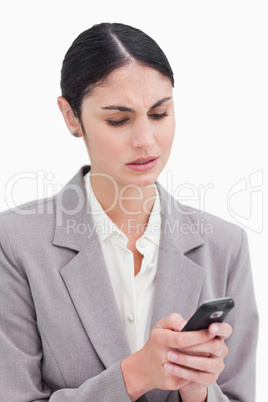 Close up of businesswoman confused by text message