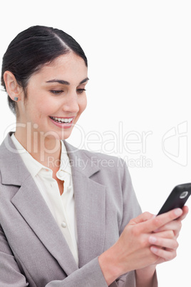 Close up of smiling businesswoman reading text message