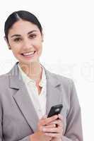 Close up of smiling businesswoman holding cellphone