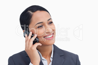 Close up of smiling saleswoman on her cellphone