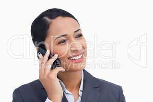 Close up of smiling saleswoman on her cellphone