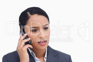 Close up of negative surprised saleswoman on her cellphone