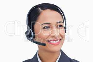 Close up of smiling call center agent looking to the side