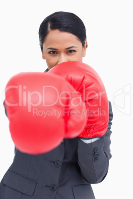 Close up of saleswoman with boxing gloves attacking