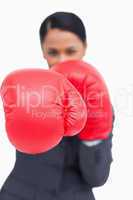 Close up of saleswoman's fist in a boxing glove
