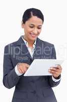 Close up of smiling saleswoman using her tablet computer