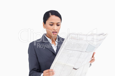 Close up of saleswoman reading news paper