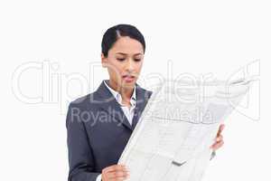 Close up of saleswoman reading news paper