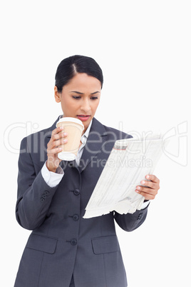 Close up of saleswoman with paper cup and news paper