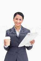Close up of smiling saleswoman with paper cup and news paper