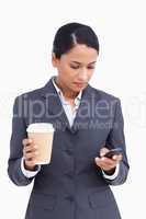 Close up of saleswoman with paper cup writing text message