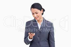 Close up of smiling saleswoman reading text message
