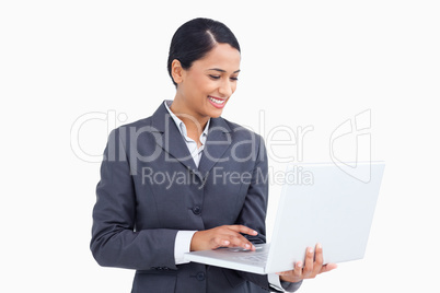 Close up of smiling saleswoman using her laptop