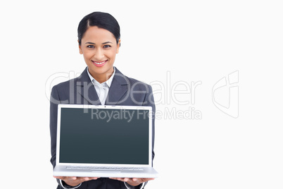 Close up of smiling saleswoman presenting laptop screen