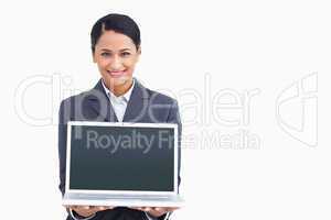 Close up of smiling saleswoman presenting laptop screen