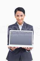 Close up of smiling saleswoman presenting screen of laptop