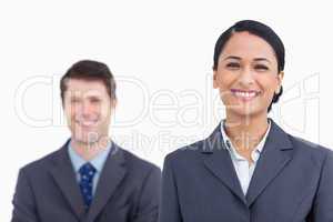 Close up of smiling saleswoman with colleague behind her