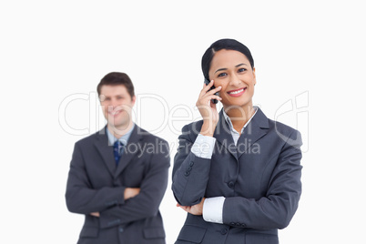 Close up of saleswoman on the phone with colleague behind her