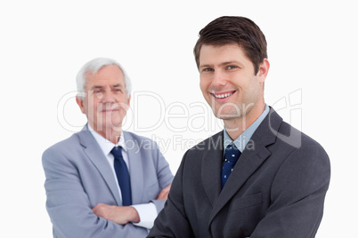 Close up of smiling businessman with his mentor behind him