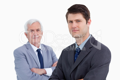Close up of young businessman with his mentor behind him