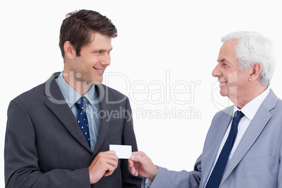 Close up of businessmen exchanging business card