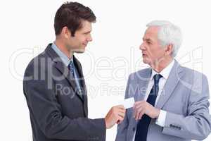 Close up of businessman giving business card to trades partner