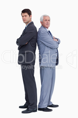 Businessmen standing back to back