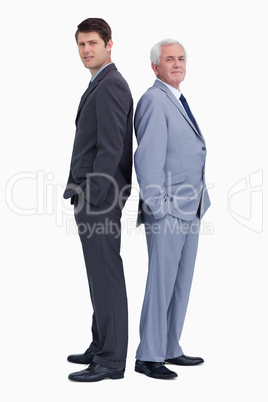 Businessman standing back to back with his mentor