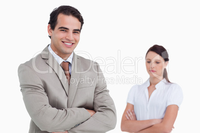 Smiling salesman with colleague behind him