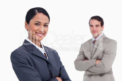 Smiling saleswoman with colleague behind her