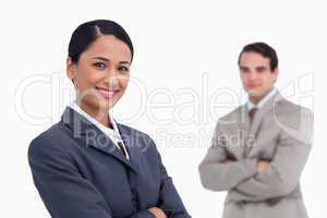 Smiling saleswoman with colleague behind her