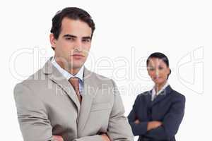 Serious salesman with colleague behind him