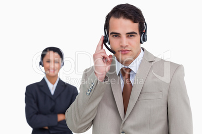 Hotline employee with colleague behind him
