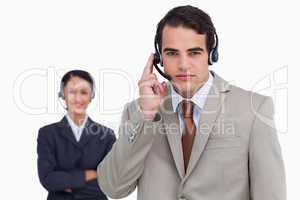 Hotline employee with colleague behind him