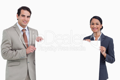 Smiling salesteam holding blank sign