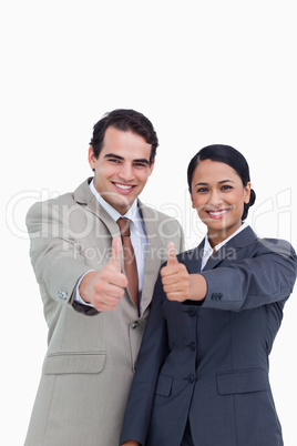 Smiling young salesteam giving thumbs up