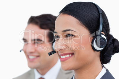 Close up side view of smiling call center agents