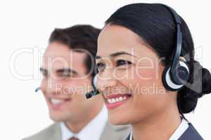 Close up side view of smiling call center agents