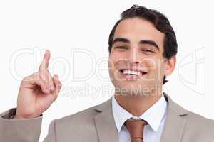 Close up of smiling salesman pointing up