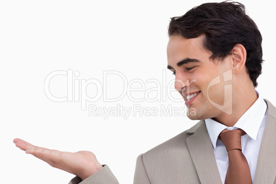 Close up of smiling salesman looking at his palm