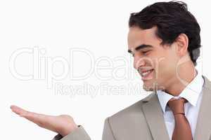 Close up of smiling salesman looking at his palm