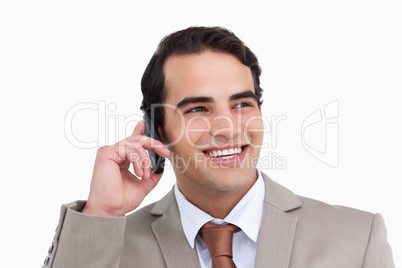 Close up of smiling salesman on his cellphone