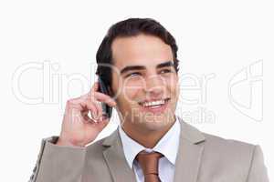 Close up of smiling salesman on his cellphone