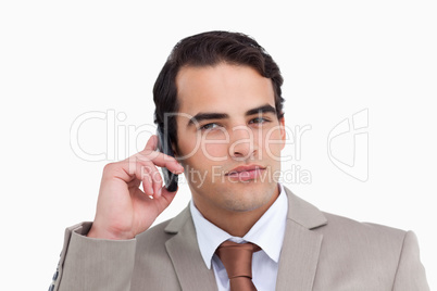 Close up of serious salesman on his mobile phone